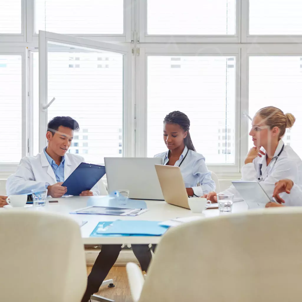 doctors aesthetics training showing doctors discussing with each other.